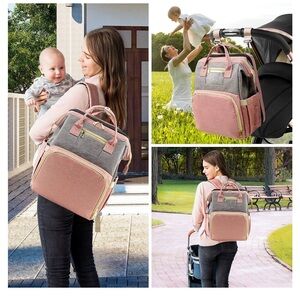 Pink, grey and cream and gold colored diapers bag with changing station.